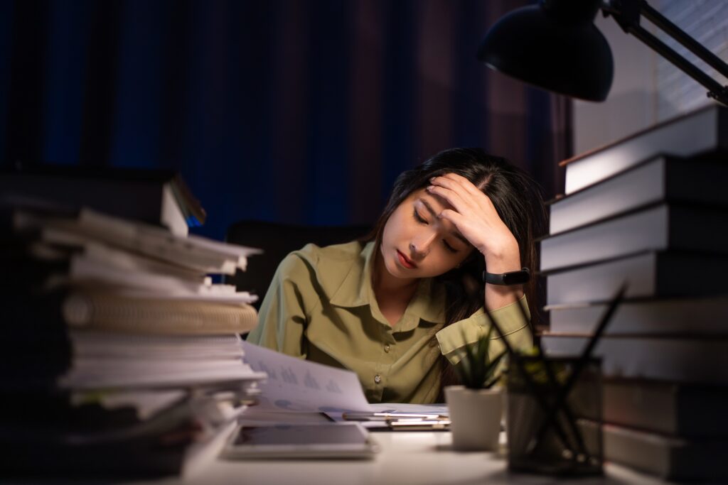 Portrait,Of,Asian,Businesswoman,Sitting,And,Working,Hard,At,With